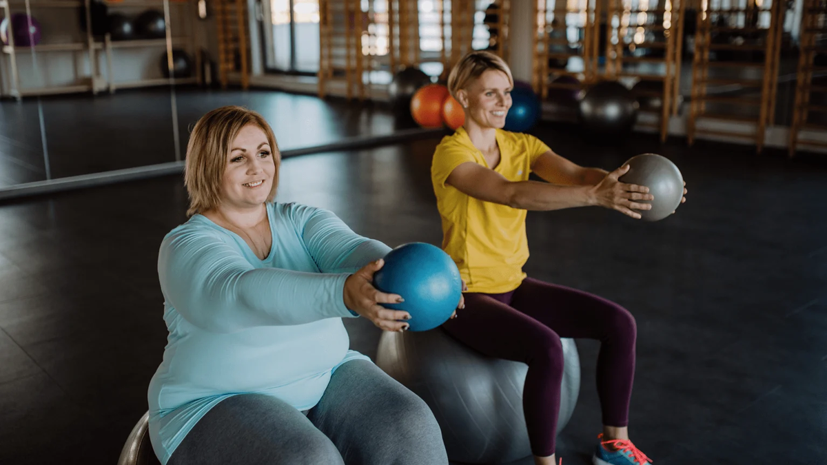 Two women exercising with inflatable yoga balls